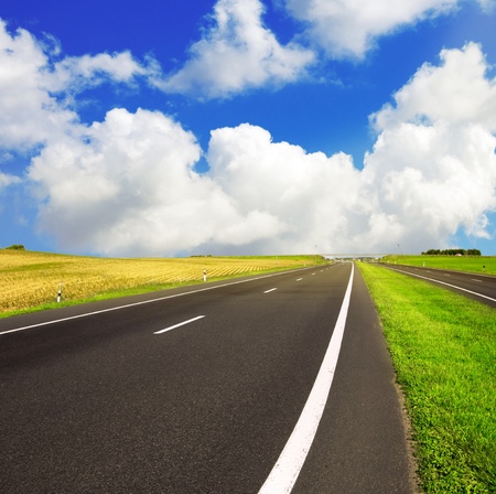 asphalt road over blue sky - travel concept の写真素材