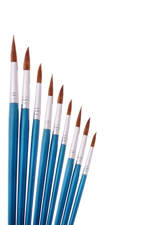 nine blue paintbrushes isolated on white backgroundの写真素材