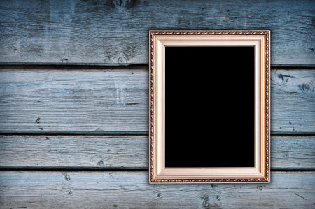 empty golden frame on grungy wooden wallの写真素材