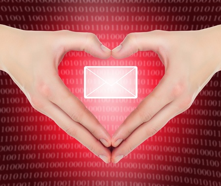 female hands in shape of a heart holding valentineの写真素材