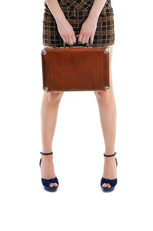 female legs  with hands holding vintage brown case - travel and vacation conceptの写真素材