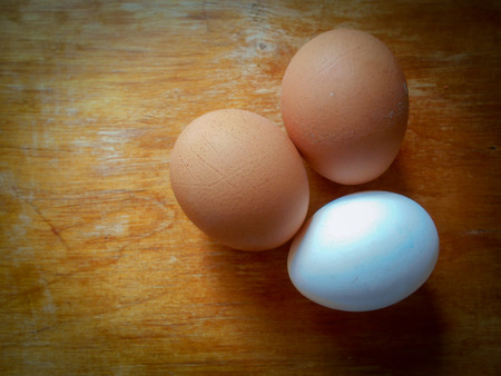 Three eggs on a wooden board.の写真素材