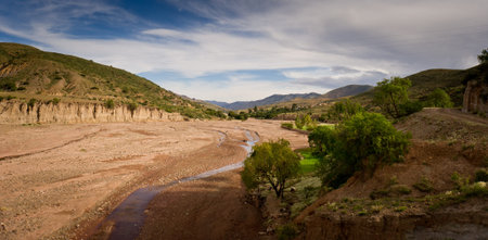 Mountains of Bolivia, altiplano, desert and green landscapes, trees and rocks, sand and water, sky...