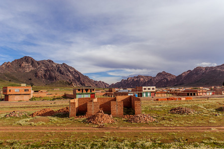 Mountains of Bolivia, altiplano, desert and green landscapes, trees and rocks, sand and water, sky and earth. Beautiful views of South America. views of the settlements from the bus windowの写真素材