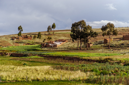 Mountains of Bolivia, altiplano, desert and green landscapes, trees and rocks, sand and water, sky and earth. Beautiful views of South America. views of the settlements from the bus windowの写真素材
