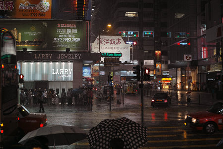 the streets of Hong Kong and its people during a tropical rain. Hong Kong Special Administrative Region of the People's Republic of China, is a city on the southern coast of China at the Pearl River Estuary and the South China Seaのeditorial素材