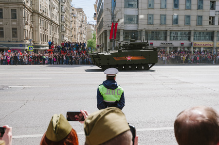 MOSCOW-MAY 9, 2015: Victory parade dedicated to the 70th anniversary of the Soviet victory over Germany. People on the streets of Moscow greeted Pass technique. Organization of view of the parade for the common people.のeditorial素材