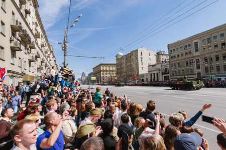 MOSCOW-MAY 9, 2015: Victory parade dedicated to the 70th anniversary of the Soviet victory over Germany. People on the streets of Moscow greeted Pass technique. Organization of view of the parade for the common people.のeditorial素材