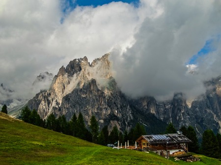 The Dolomites are a mountain range located in northeastern Italy. They form a part of the Southern Limestone Alps and extend from the River Adige in the west to the Piave Valley  in the east. Green slopes of the foot of the Italian Alpsの写真素材