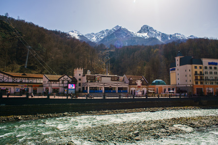 Ski resort in the Valley Rosa Khutor Located on the shore of a mountain river in the valleyの写真素材