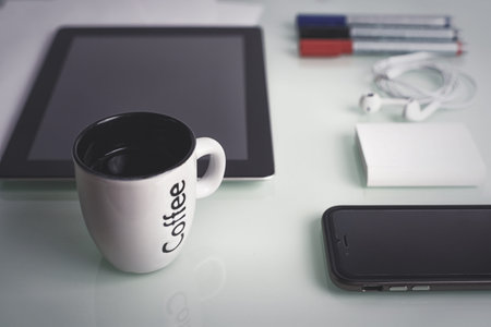 smartphone and a tablet and color markers with a sheet of paper on the table concept for a Web siteの写真素材