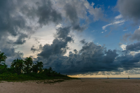 A beautiful sunset view from the beach in Cuba on a beautiful dark clouds and palm treesの写真素材
