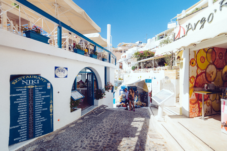 Greece, Santorini - October 01, 2017: vacationing people on the narrow streets of white cities on the island. Favorite place of all lovers.のeditorial素材