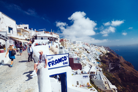 Greece, Santorini - October 01, 2017: vacationing people on the narrow streets of white cities on the island. Favorite place of all lovers.のeditorial素材
