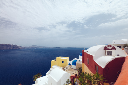 Greece, Santorini - October 01, 2017: vacationing people on the narrow streets of white cities on the island. Favorite place of all lovers.のeditorial素材