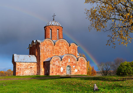 Russian ancient brick church against a rainbowの写真素材