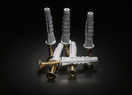 Screws and dowels on a black backgroundの写真素材