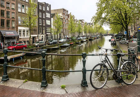 Amsterdam, Netherlands - May 2, 2022: Canal bridge, street housesのeditorial素材