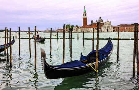 Venice, Italy - May 25, 2022: Gondola on Grand canal. Saint George church (San Georgio basilica) island view.のeditorial素材