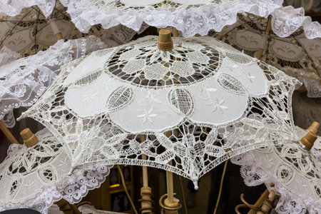 white umbrellas. Sun protection, hot weather concept. Traditional souvenirs in Burano island,...