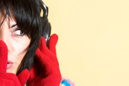 beautiful woman listening music in headphones gestures for silence, shhhの写真素材