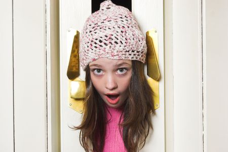 Girl head stuck in accordion doorの写真素材