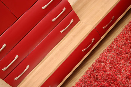 Details of red drawer in sitting-room, wooden interiorの写真素材