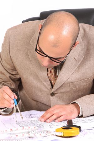 A Businessman working with architectural plansの写真素材