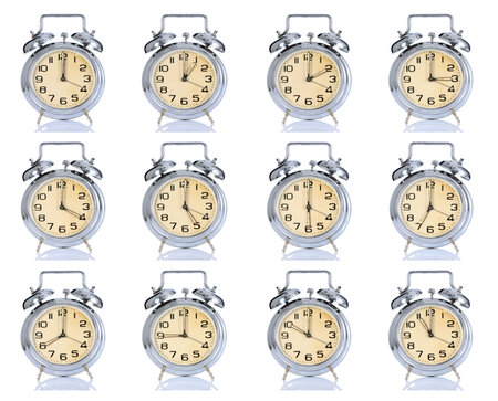 group of alarm clock with times 12 clock on white backgroundの写真素材