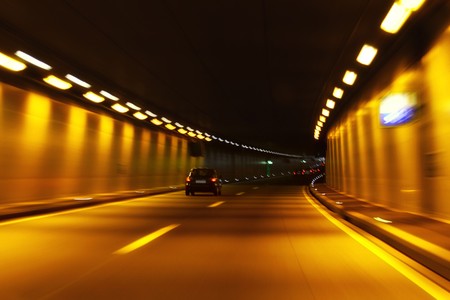 Car trails in motion through a tunnel の写真素材
