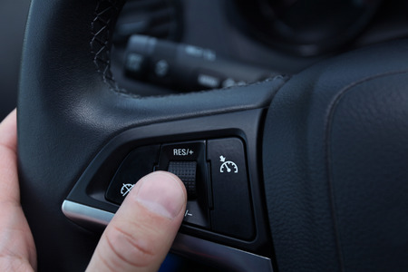 speed limitation and cruise control buttons on a steering wheel in modern carの写真素材