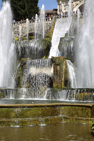 TIVOLI, ITALY - APRIL 10, 2015: Tourists visiting Fountain of Neptune and Organ in Villa d'Este in Tivoli. Villa d`Este fountain and garden in Tivoli near Roma, Italy on April 10, 2015.のeditorial素材