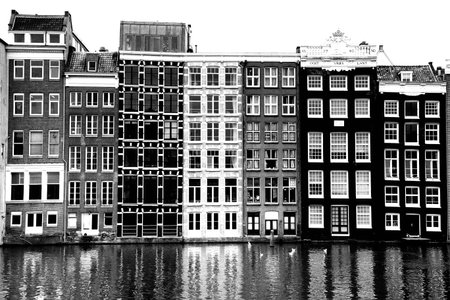 AMSTERDAM; THE NETHERLANDS - AUGUST 16; 2015: Beautiful views of the ancient buildings at the waterside, Damrak canal in Amsterdam. Amsterdam is capital of the Netherlands on August 16; 2015.のeditorial素材