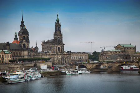 DRESDEN, GERMANY â AUGUST 13, 2016: Tourists walk and majestic view on Katholische Hofkirche from bridge CarolabrÃ¼cke in Dresden, State of Saxony, Germany on August 13, 2016.のeditorial素材