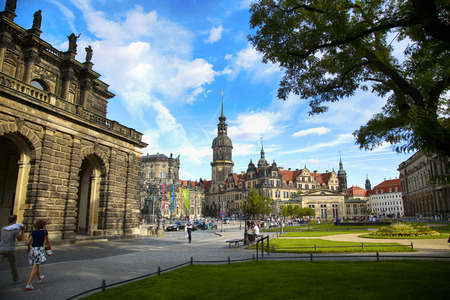 DRESDEN, GERMANY â AUGUST 13, 2016: Tourists walk on Theaterplatz street and majestic view on  Saxony Dresden Castle (Residenzschloss) in Dresden, State of Saxony, Germany on August 13, 2016.のeditorial素材
