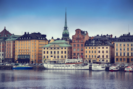 STOCKHOLM, SWEDEN - AUGUST 20, 2016: View of Gamla Stan from bridge Skeppsholmsbron. Old buildings on Stockholm quay and touristic sightseeing boats in Stockholm, Sweden on August 20, 2016.のeditorial素材