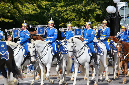 STOCKHOLM, SWEDEN - AUGUST 20, 2016: Swedish Royal Guards on horse in blue uniforms in the dayly procession on Stromgatan street in Stockholm, Sweden on August 20, 2016.のeditorial素材