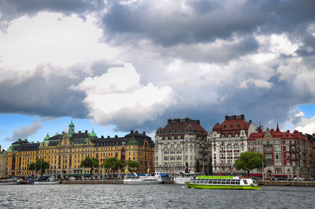 STOCKHOLM, SWEDEN - AUGUST 20, 2016: Many people walk and visit on Strandvagen street on Ostermalm distric with touristic sightseeing boats in Stockholm, Sweden on August 20, 2016.のeditorial素材