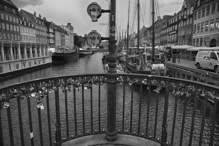 COPENHAGEN, DENMARK - AUGUST 15, 2016: Black and white photo, boats in the docks Nyhavn, people, and colorful architecture. Nyhavn a 17th century harbour in Copenhagen, Denmark on August 15, 2016.のeditorial素材