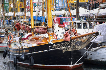 COPENHAGEN, DENMARK - AUGUST 15, 2016: Boats in the docks Nyhavn, people, restaurants and colorful architecture. Nyhavn a 17th century harbour in Copenhagen, Denmark on August 15, 2016.のeditorial素材