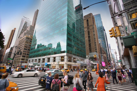 New York, USA – August 20, 2018: Busy sidewalk at the intersection 6th Avenue and 42nd Street near...