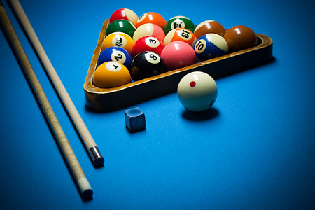 Image of billiard balls, cue and chalk on blue table.の写真素材