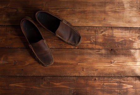 brown moccasins on a wooden backgroundの写真素材