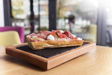 Tasty sandwich with vegetables and cheese on plate in cafe.の写真素材