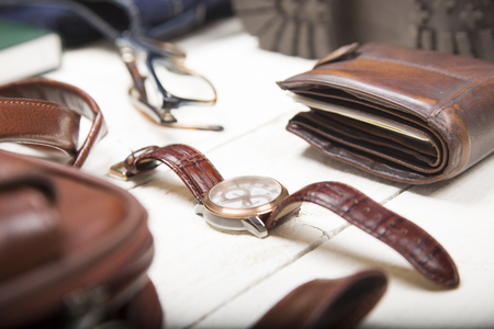 Men's casual outfits with leather accessories on white rustic wooden background, lifestyle traveler, beauty and fashion concept.の写真素材