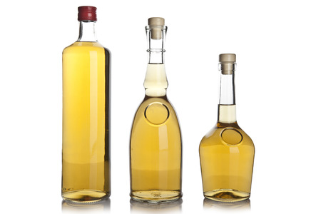 Glass bottle of brandy isolated on whiteの写真素材
