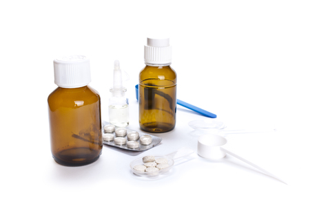 Different medical bottles and tablets isolated on white backgroundの写真素材