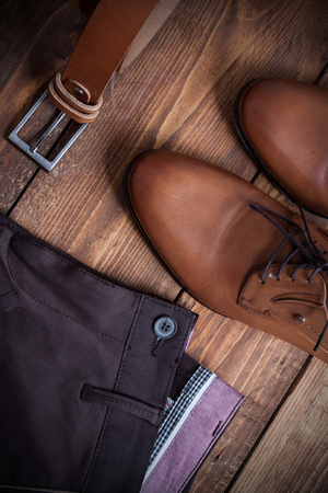 Collage of modern men's clothing on a brown wooden background..の写真素材