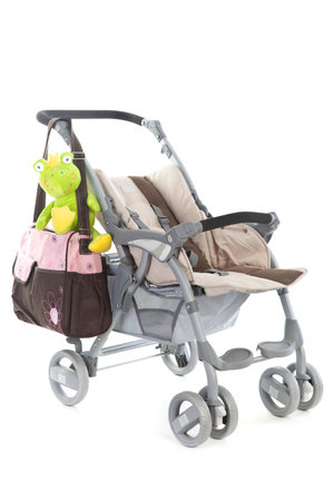 Stroller with bags, and toys isolated on white
