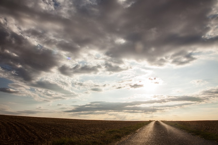 country road with surprisingly beautiful sky in the middle of the france in europe.の写真素材
